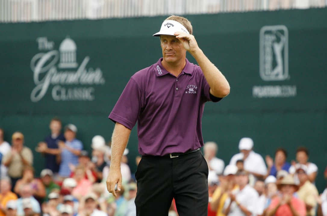 Stuart Appleby Holding A Visor Cap Background