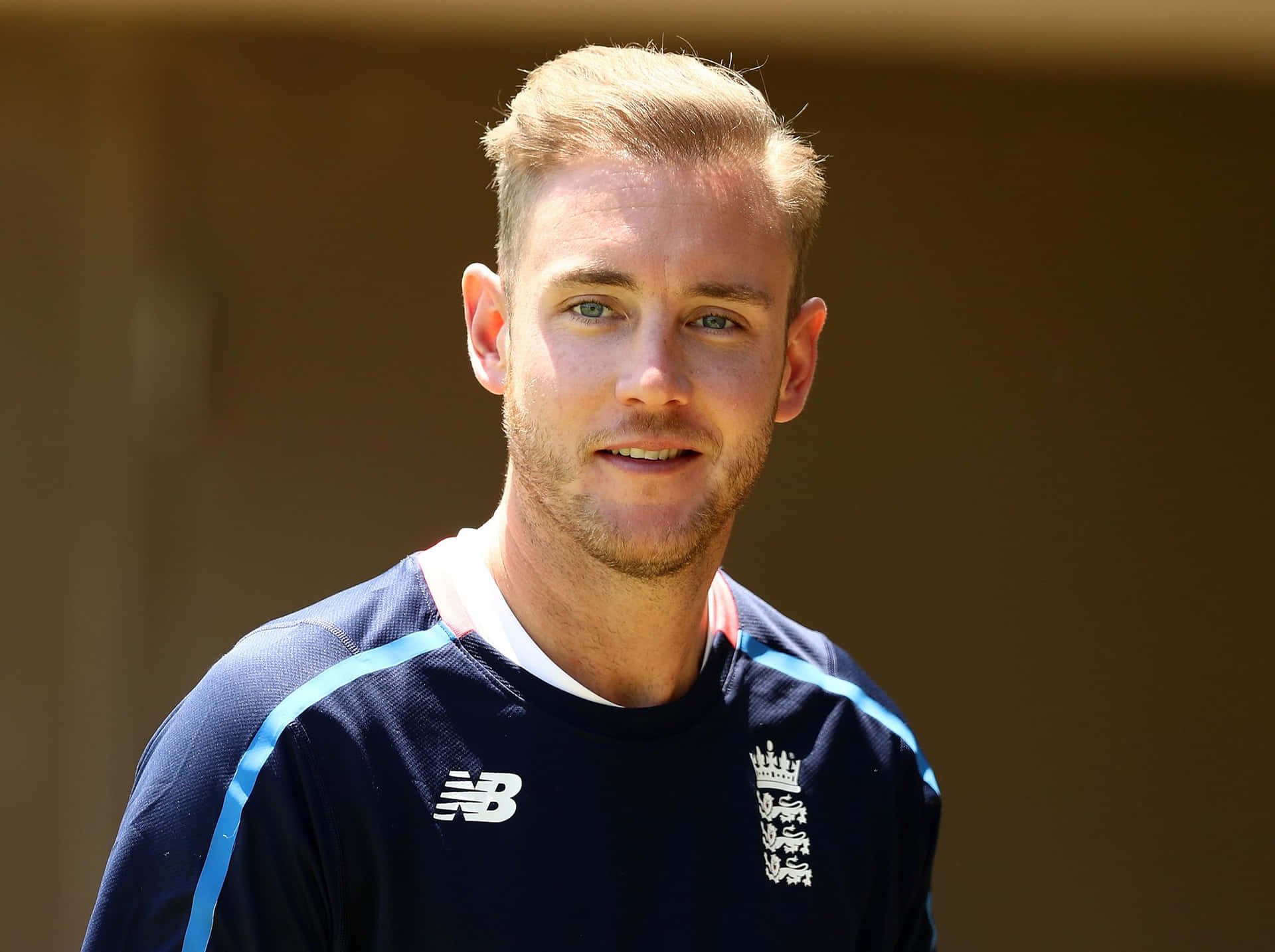 Stuart Broad Expressing Joy With A Wide Smile Background