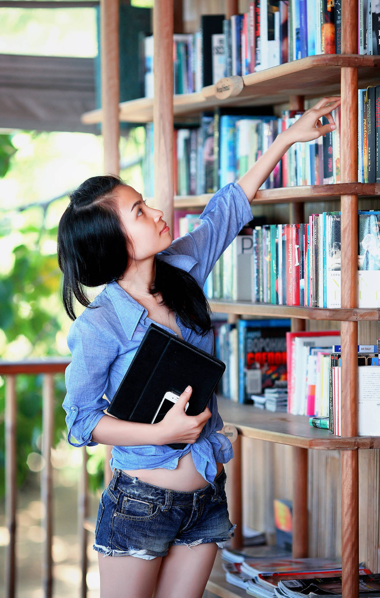 Student Reaching High For Reference Book Background