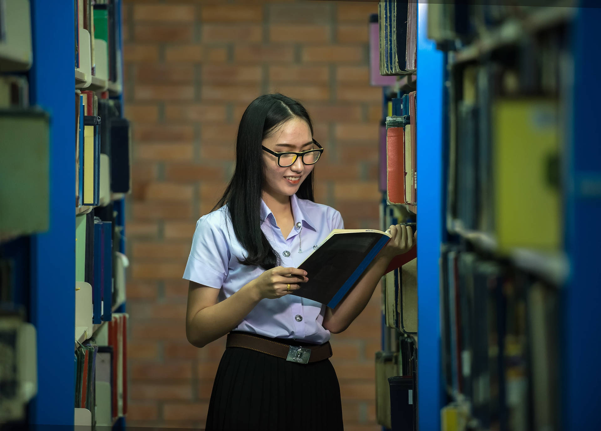 Student Reading Reference Book In Aisle