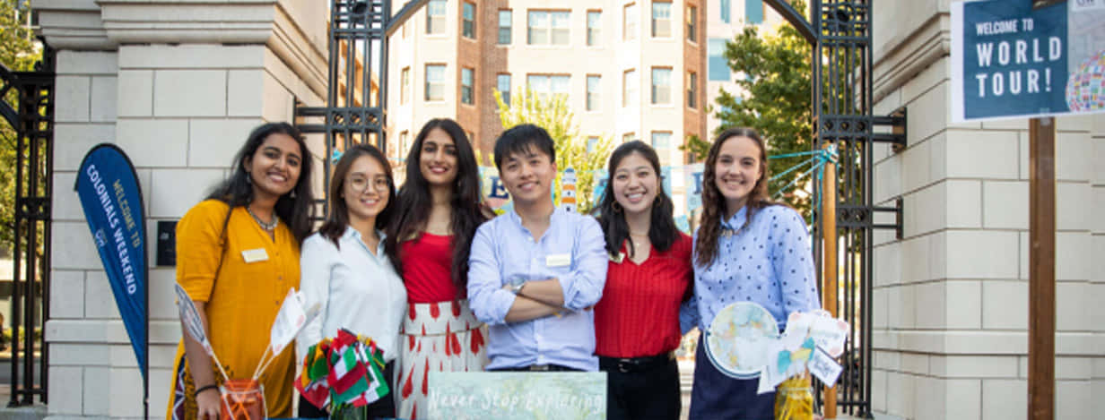 Students Smiling At George Washington University Gate Background