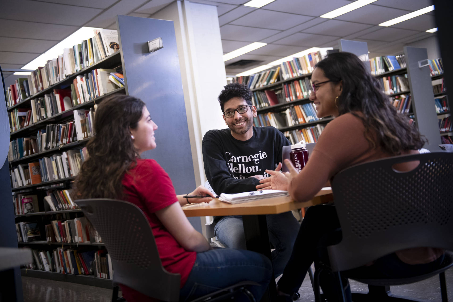 Students Talking At Carnegie Mellon University Library Background