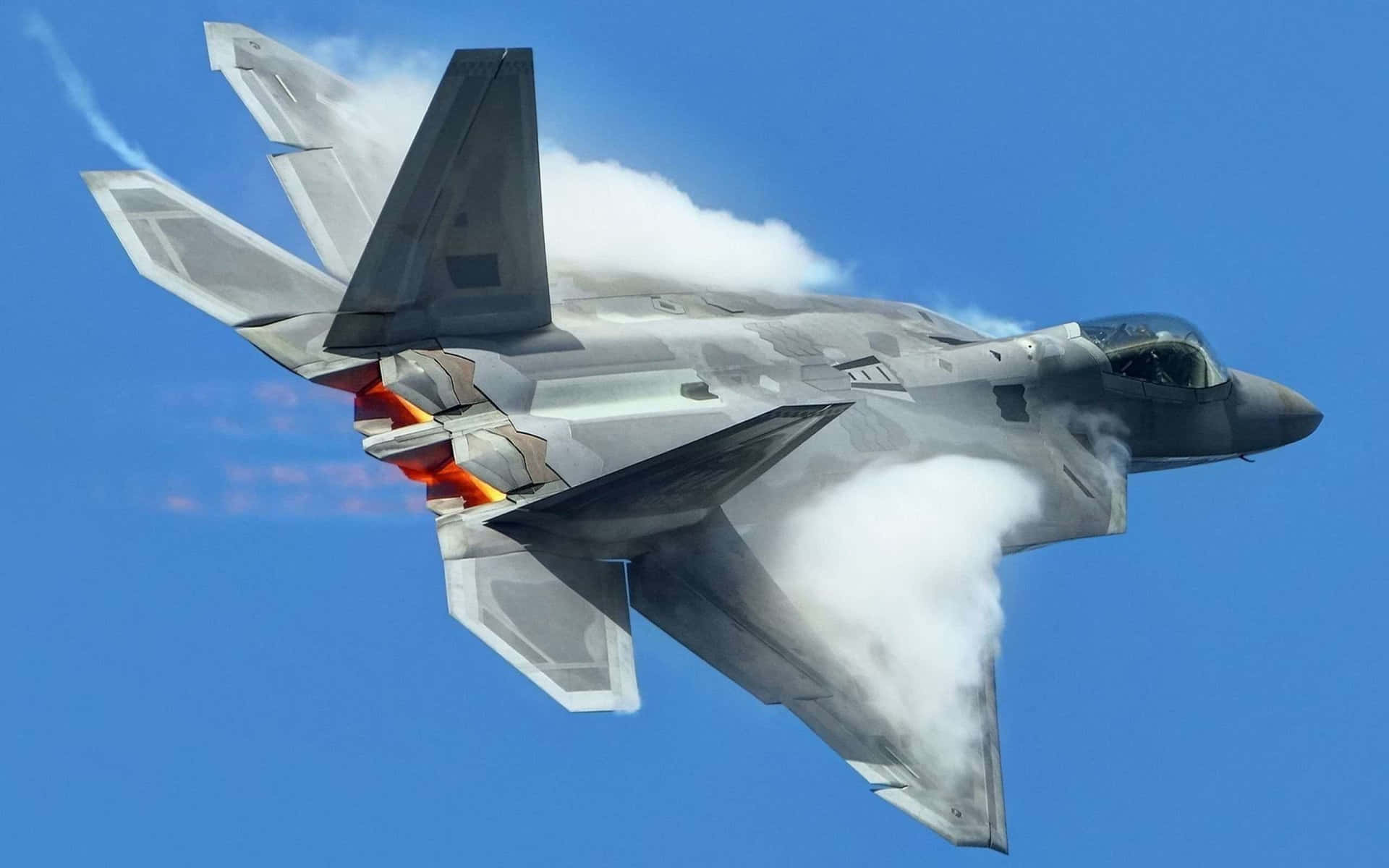 Stunning F-22 Raptor Military Jet Flying Over The Clouds Background
