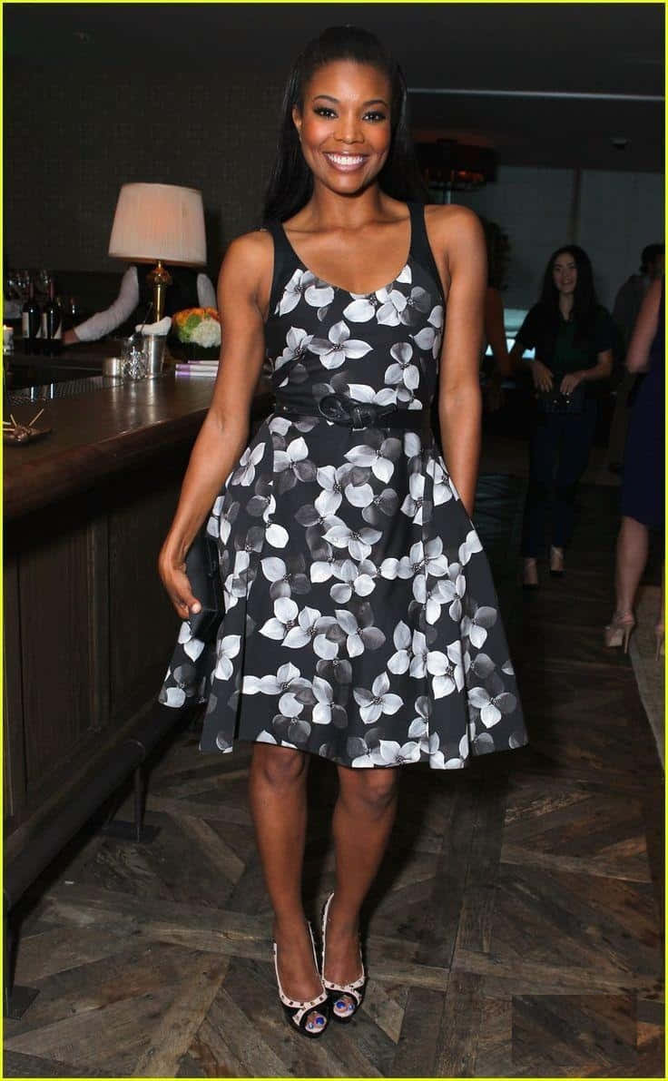 Stunning Gabrielle Union Posing In An Elegant Red Outfit Background