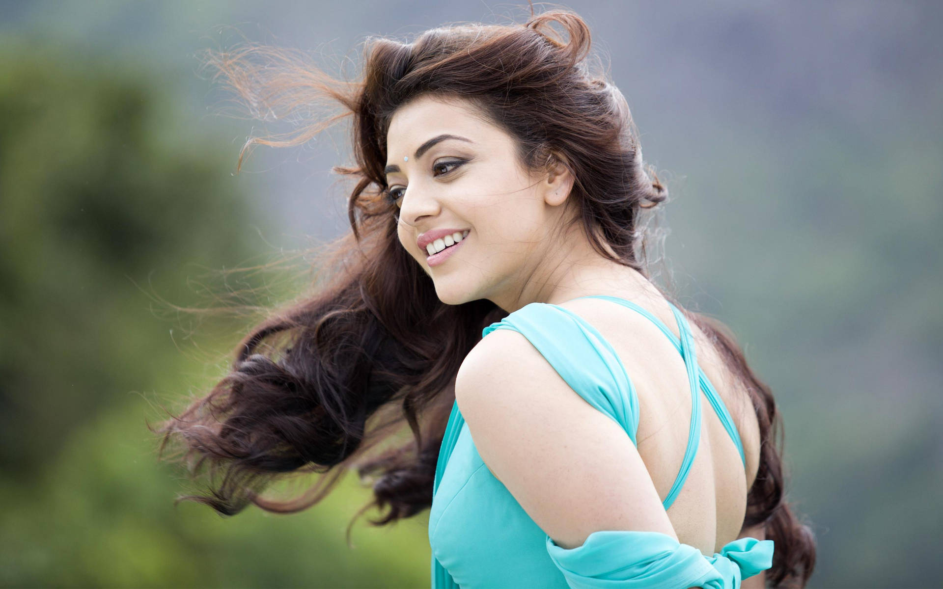 Stunning Hd Image Of Actress Kajal Agarwal With Flowing Hair Background