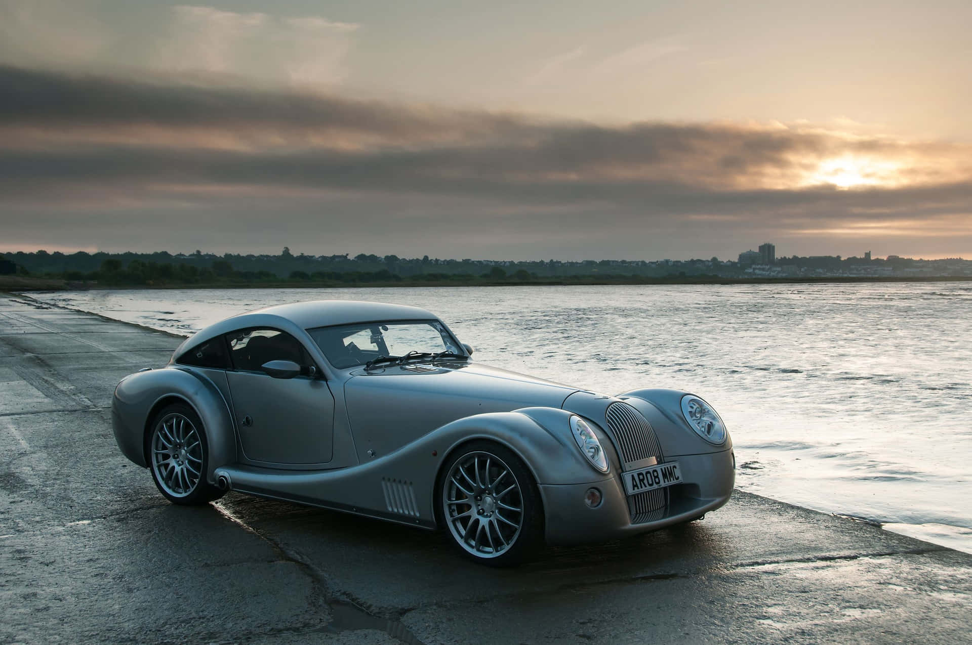 Stunning Morgan Sports Car On Scenic Road Background