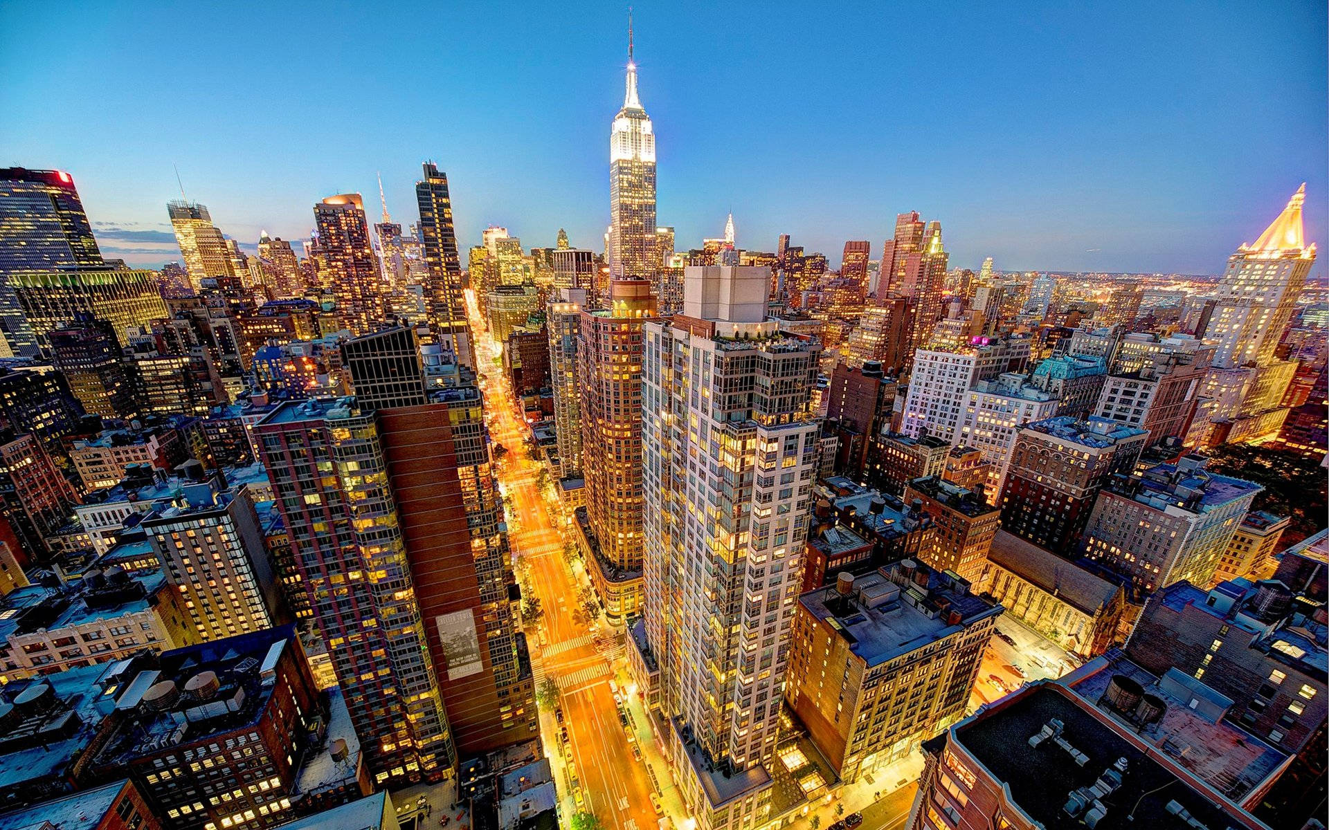 Stunning New York City Skyline Gleaming During Sunset Background