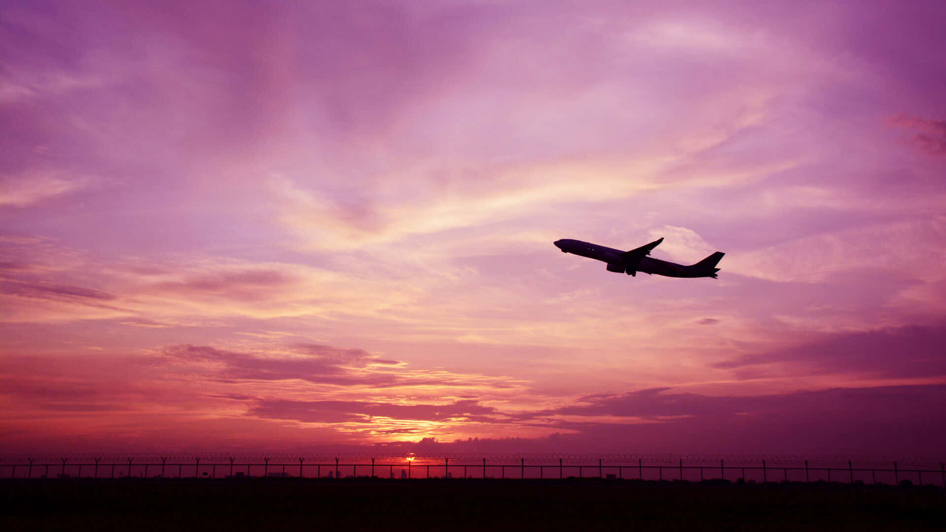 Stunning Pink Airplane Gliding Through The Sky Background