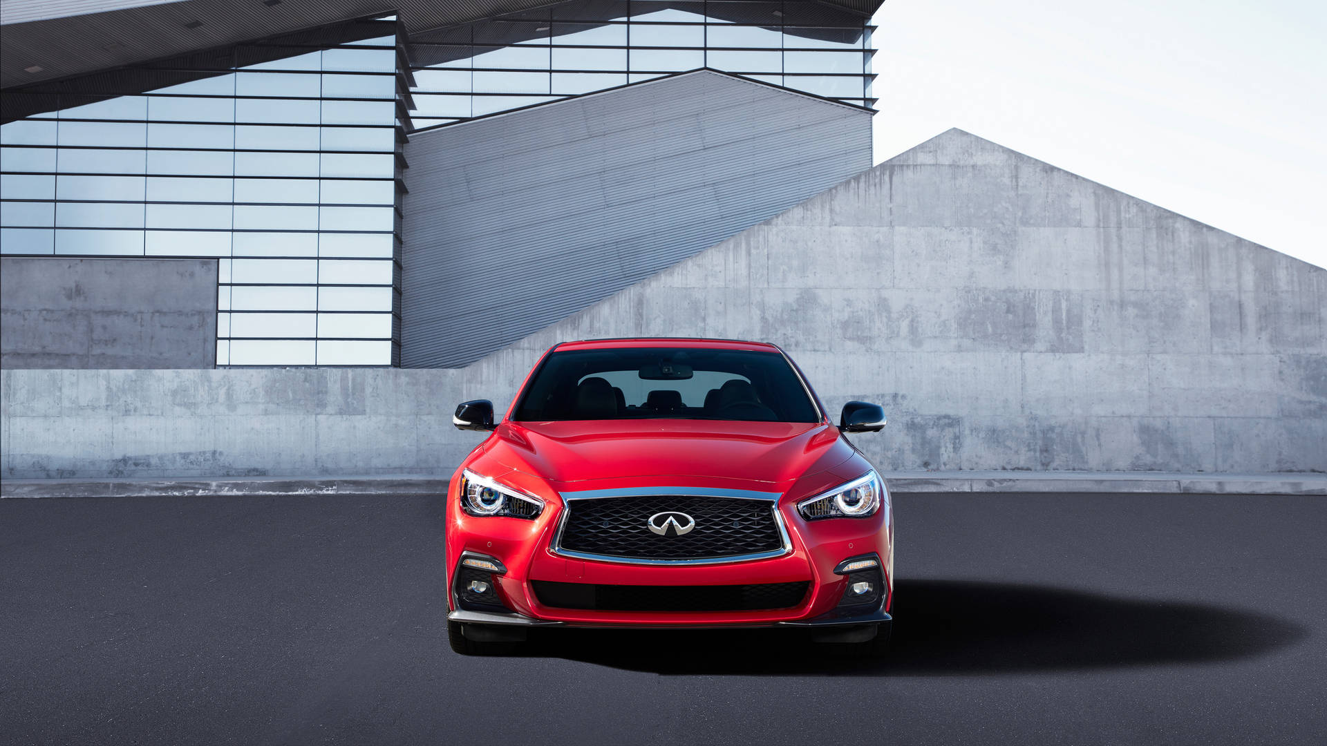 Stunning Red Infiniti Q50 On The Road Background