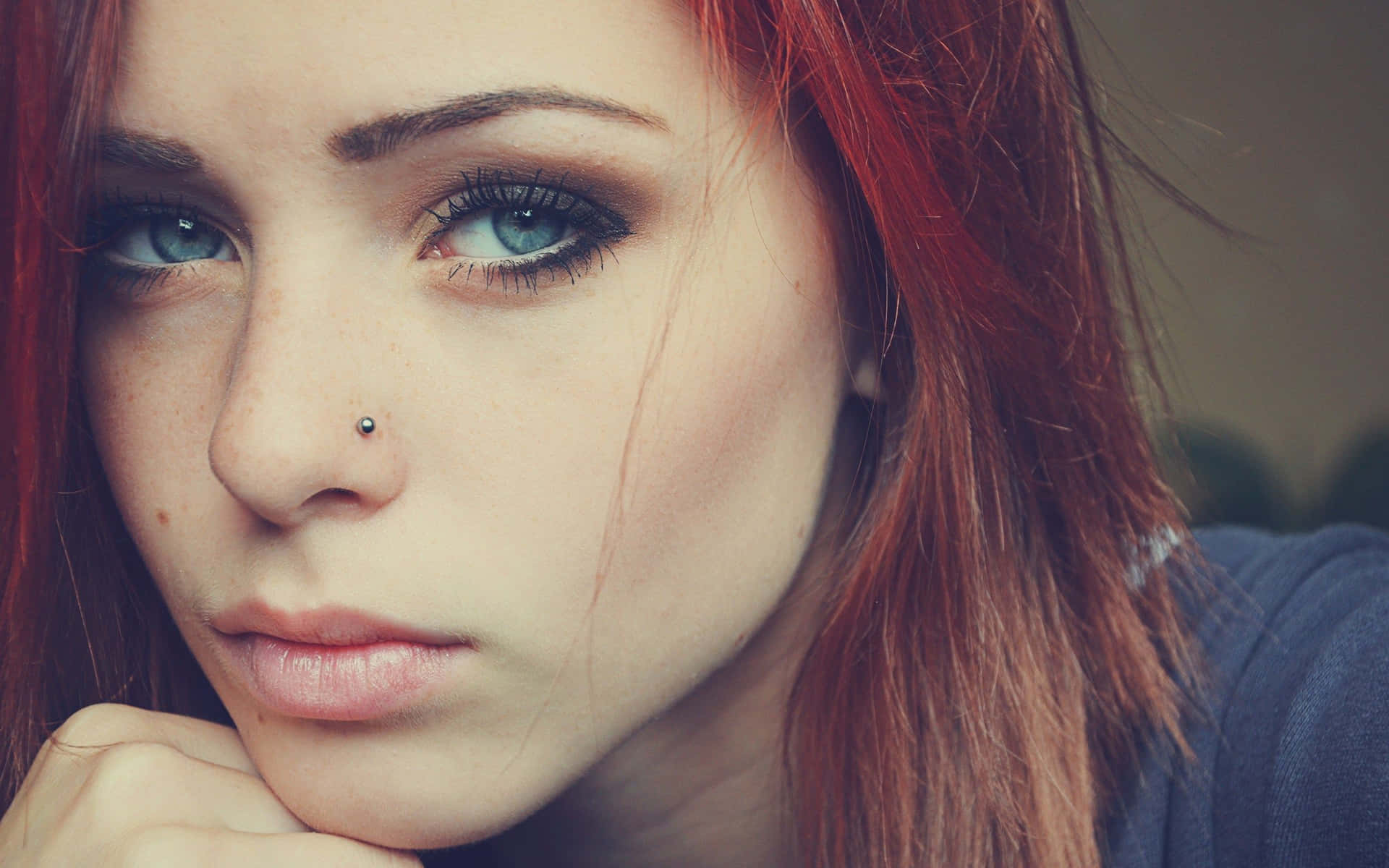 Stunning Redhead Girl Showcasing Unique Piercing Background