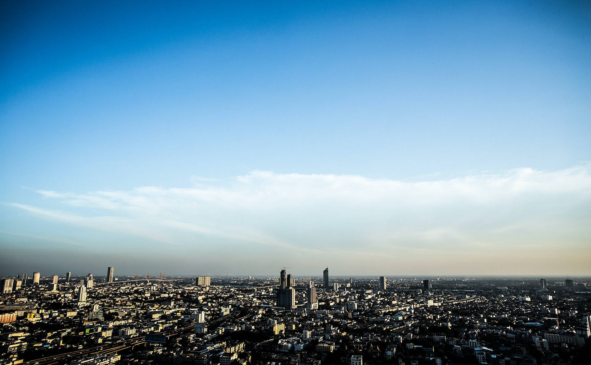 Stunning Skyline - City Braced Against A Dazzling Sky Background