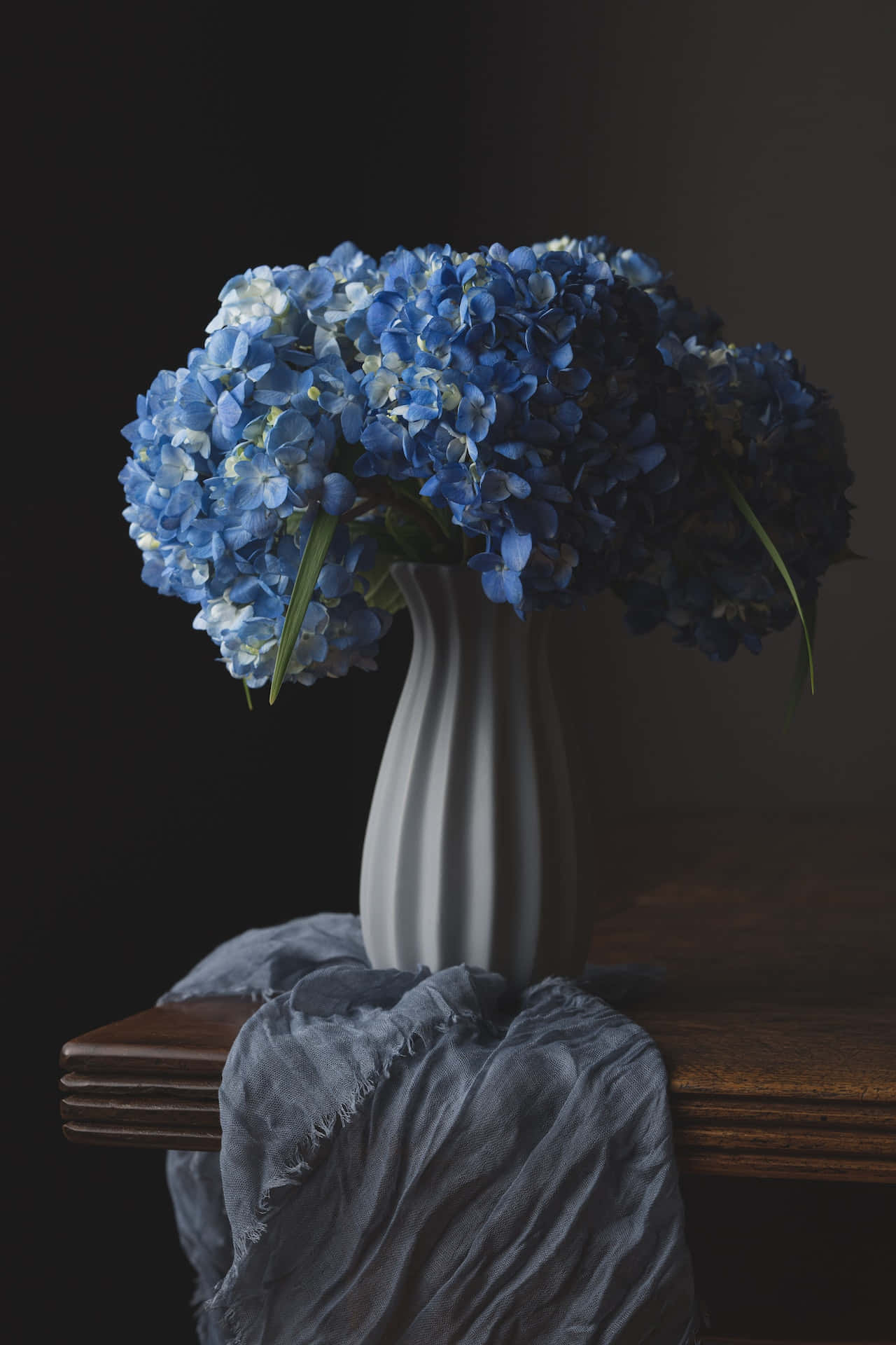 Stunning Vase Of Blue Flowers For Phone Screens Background