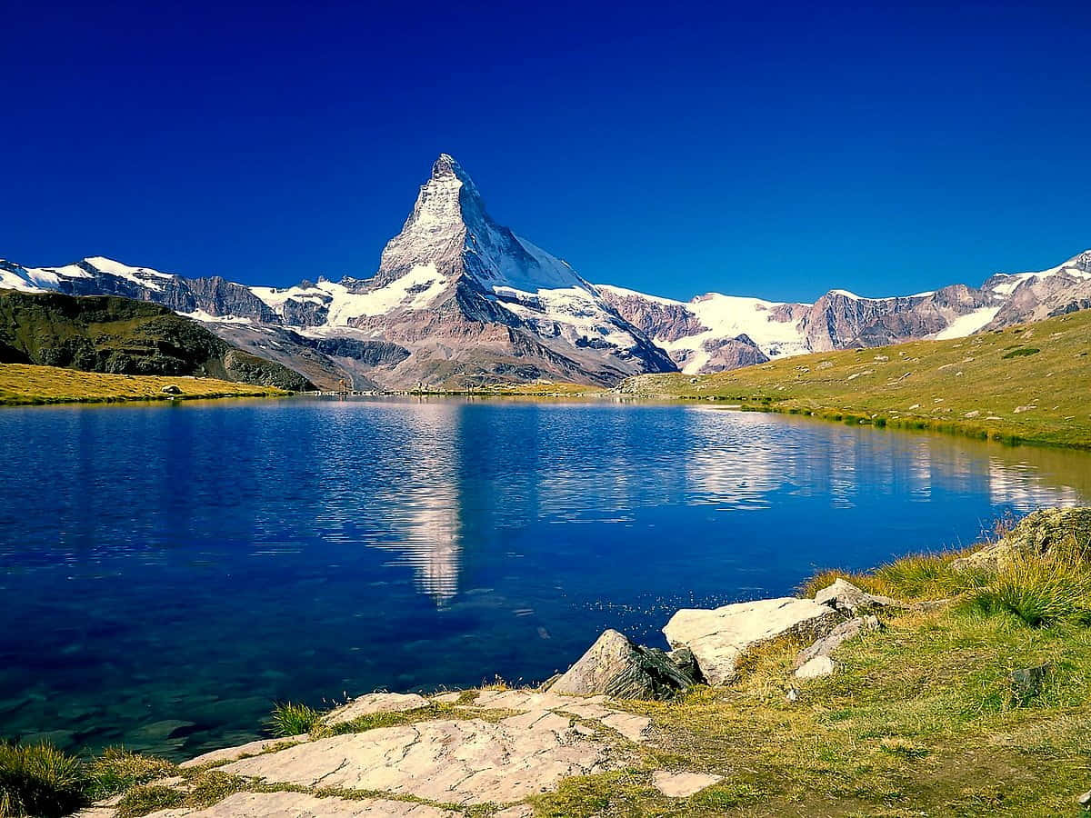 Stunning View Of Matterhorn And Stellisee Lake Background