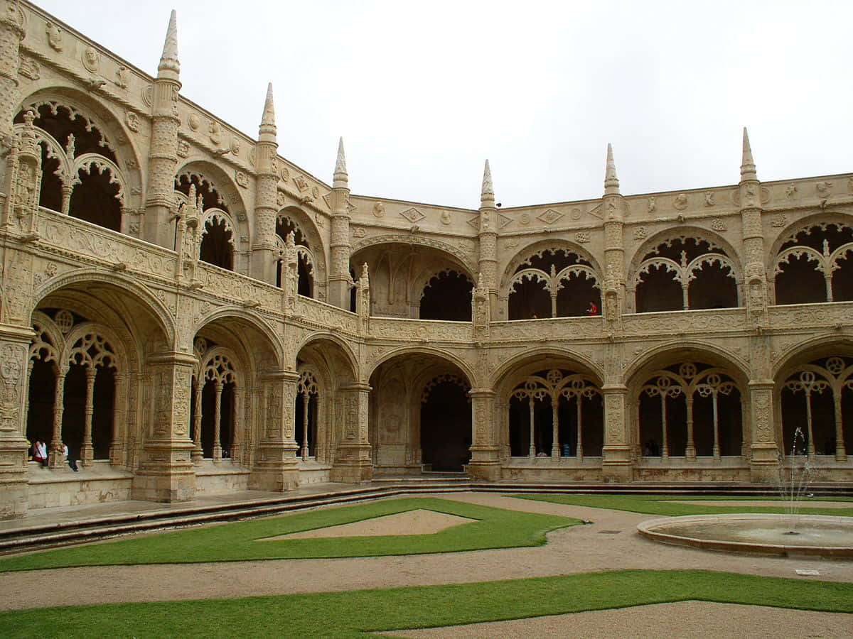 Stunning View Of The Mosteiro Dos Jeronimos Courtyard In Lisbon, Portugal Background