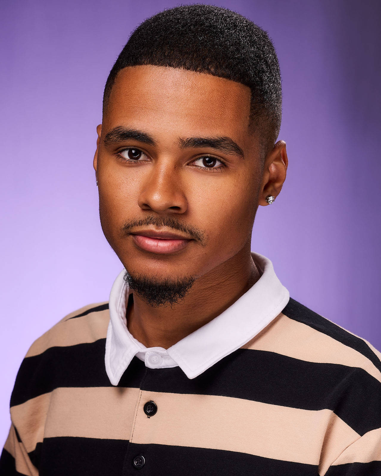 Stylish African American Man In Striped Shirt Background