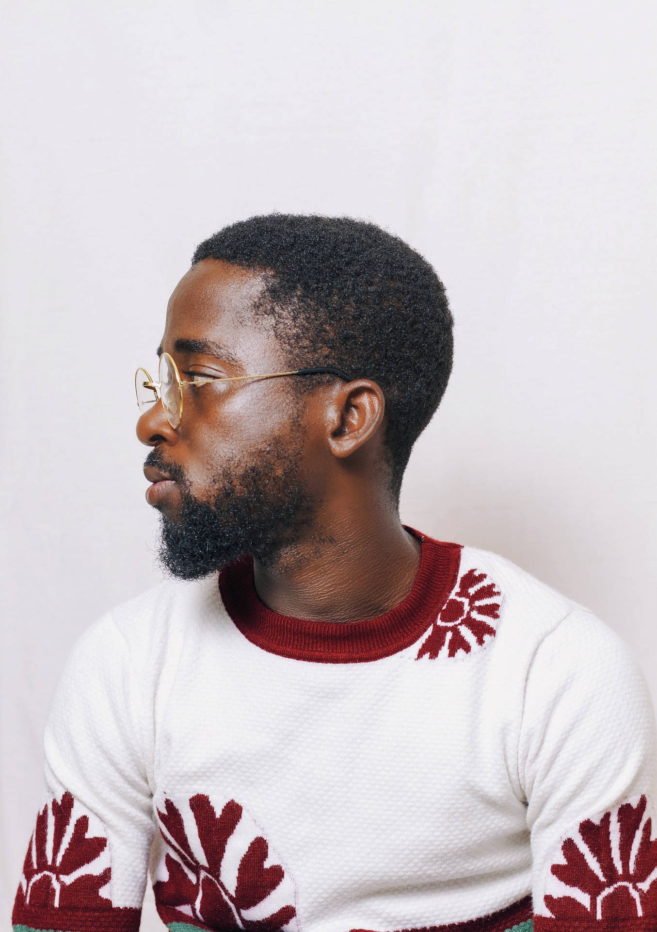 Stylish African Man In Red And White Sweater Background