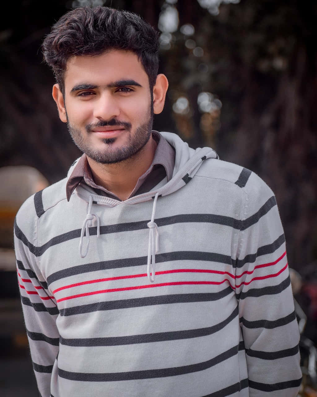 Stylish Indian Man Posing In A Bokeh Background Background