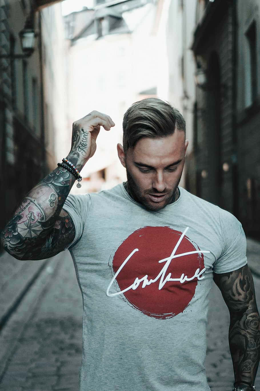 Stylish Individual Showcasing Arm Tattoos Background