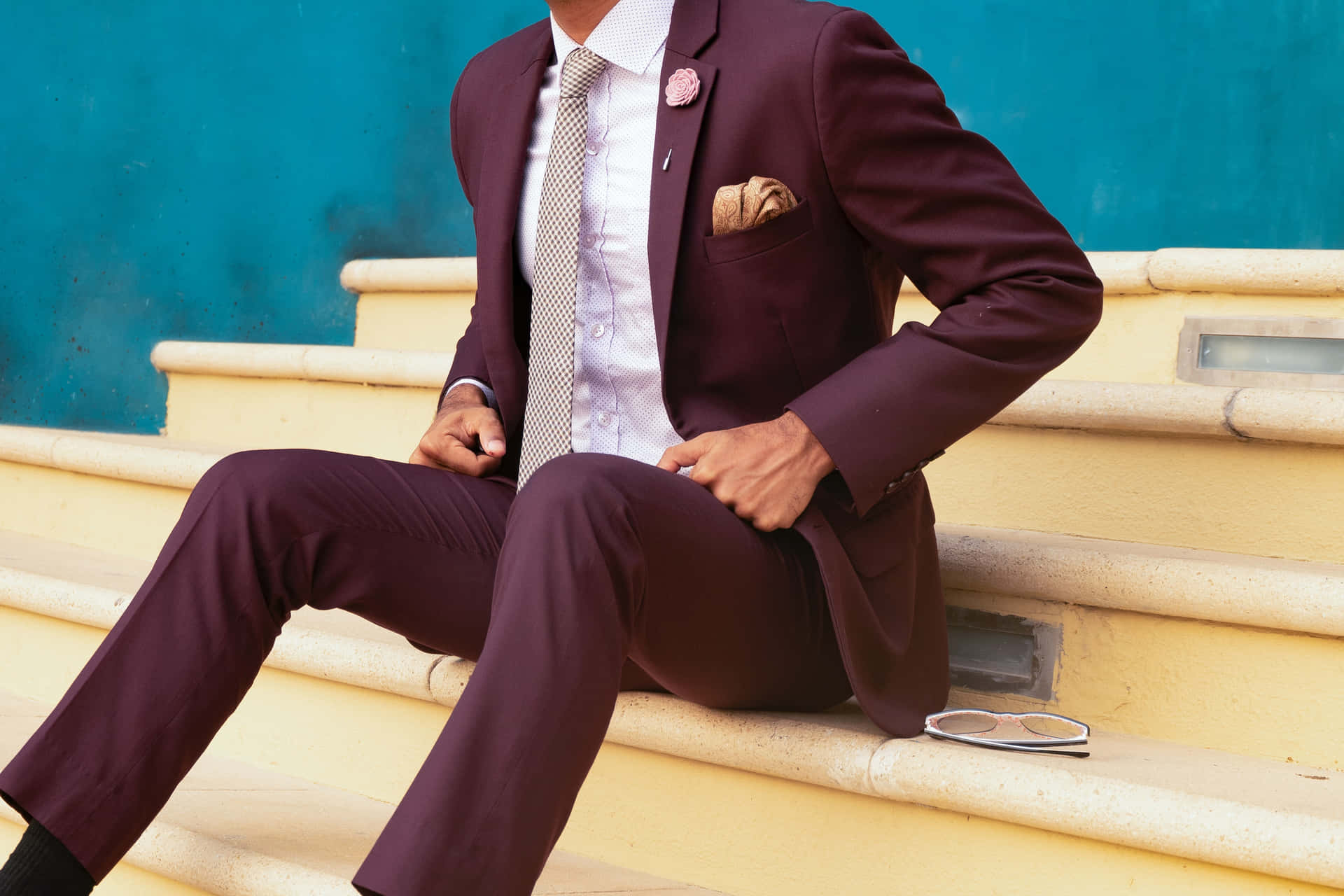 Stylish Man In Suit Posing On Yellow Stairs Background