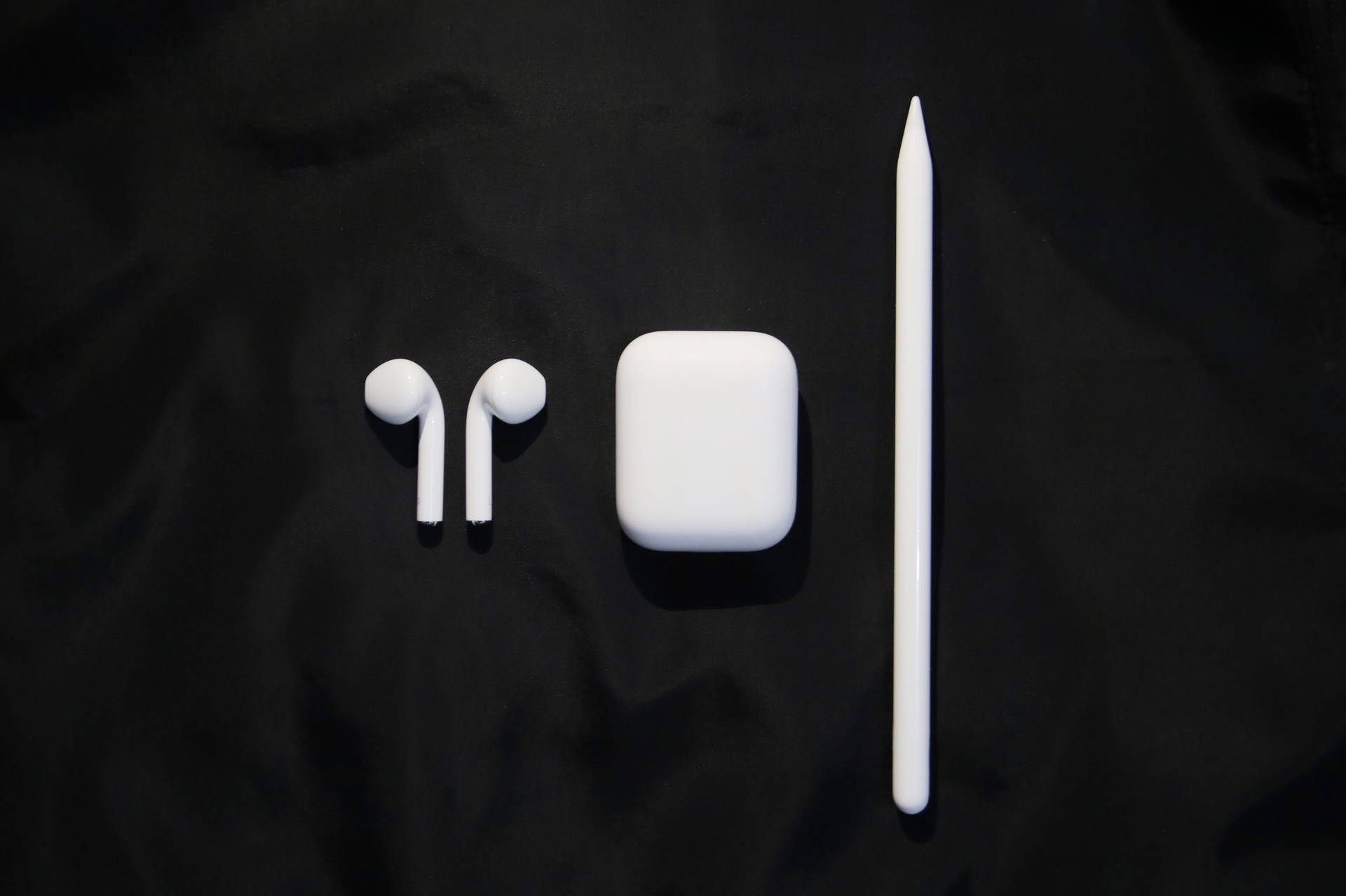 Stylish White Airpods With Accessories Background