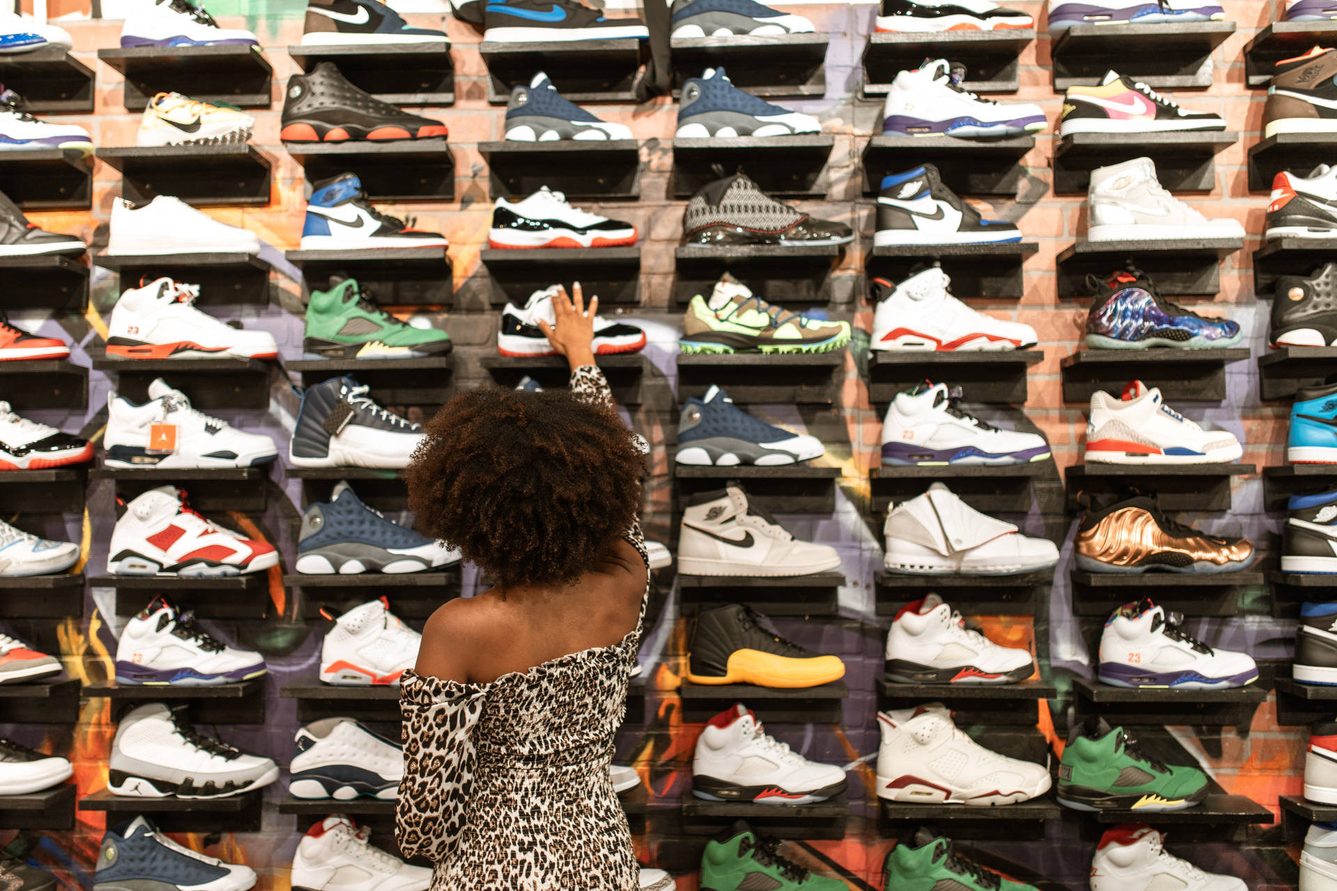 Stylish Woman Choosing Footwear By Shoe Rack. Background