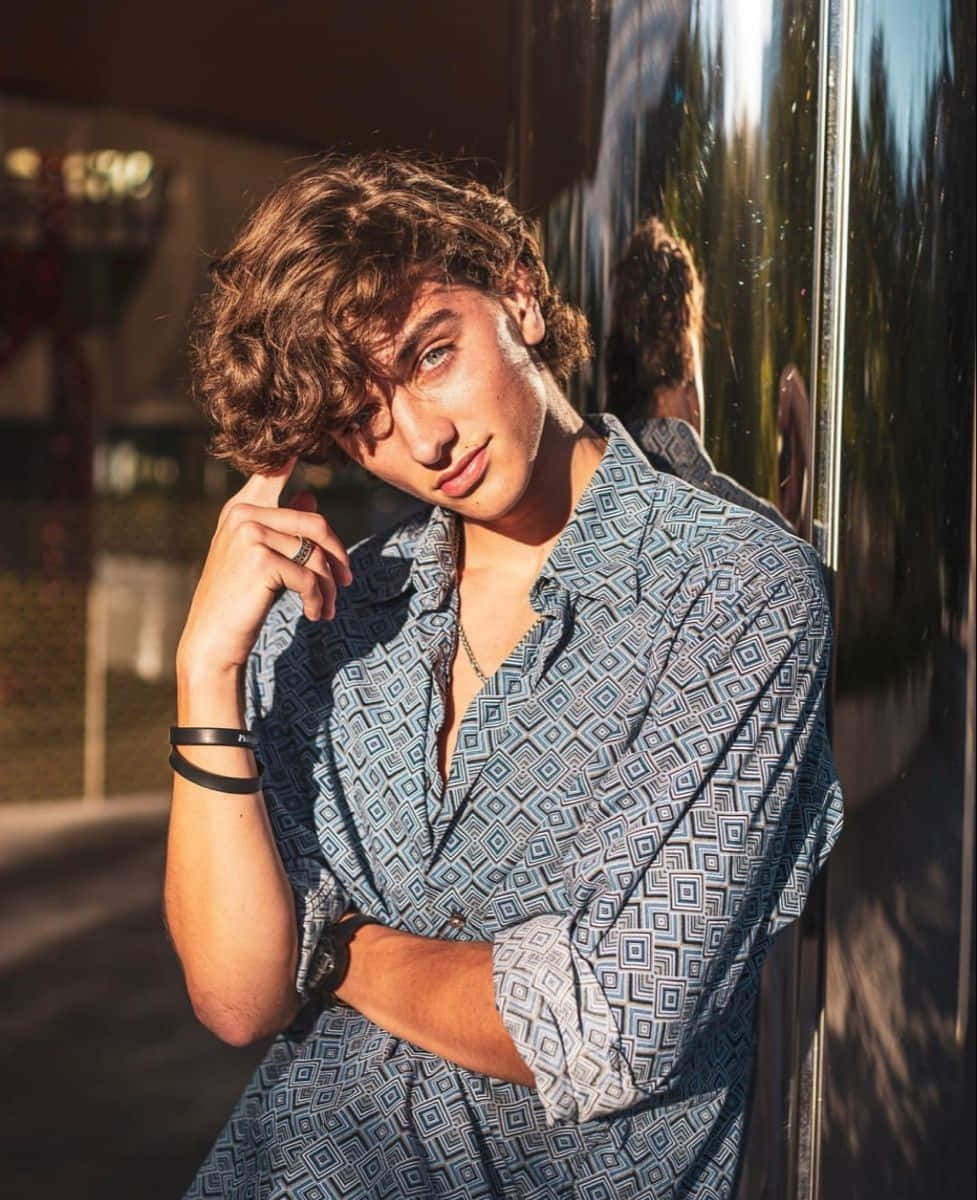 Stylish Young Man Leaning Against Wall Background