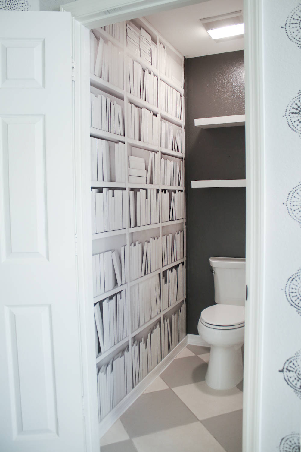 Stylishly Designed Monochromatic Interior With A Toilet And Bookshelves