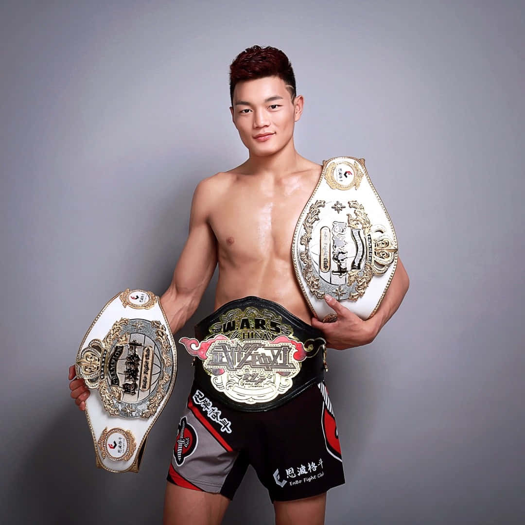 Su Mudaerji Posing With Title Belts