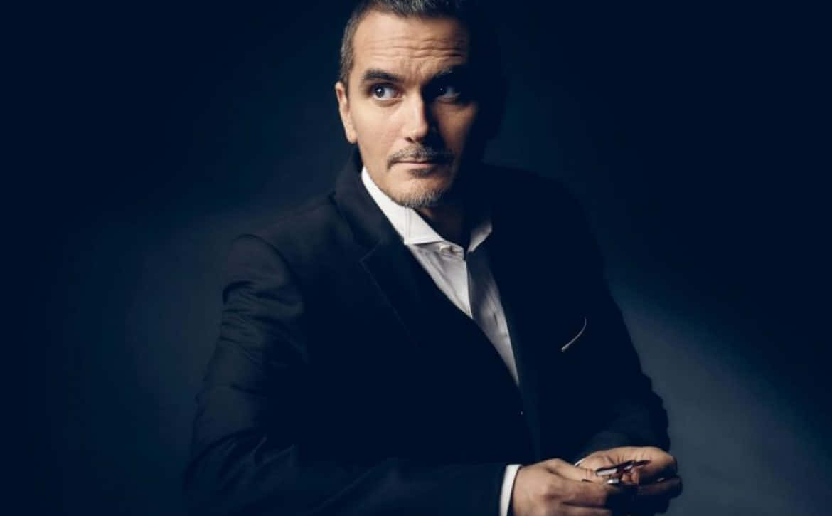 Suave Man In Black Suit [wallpaper] Background