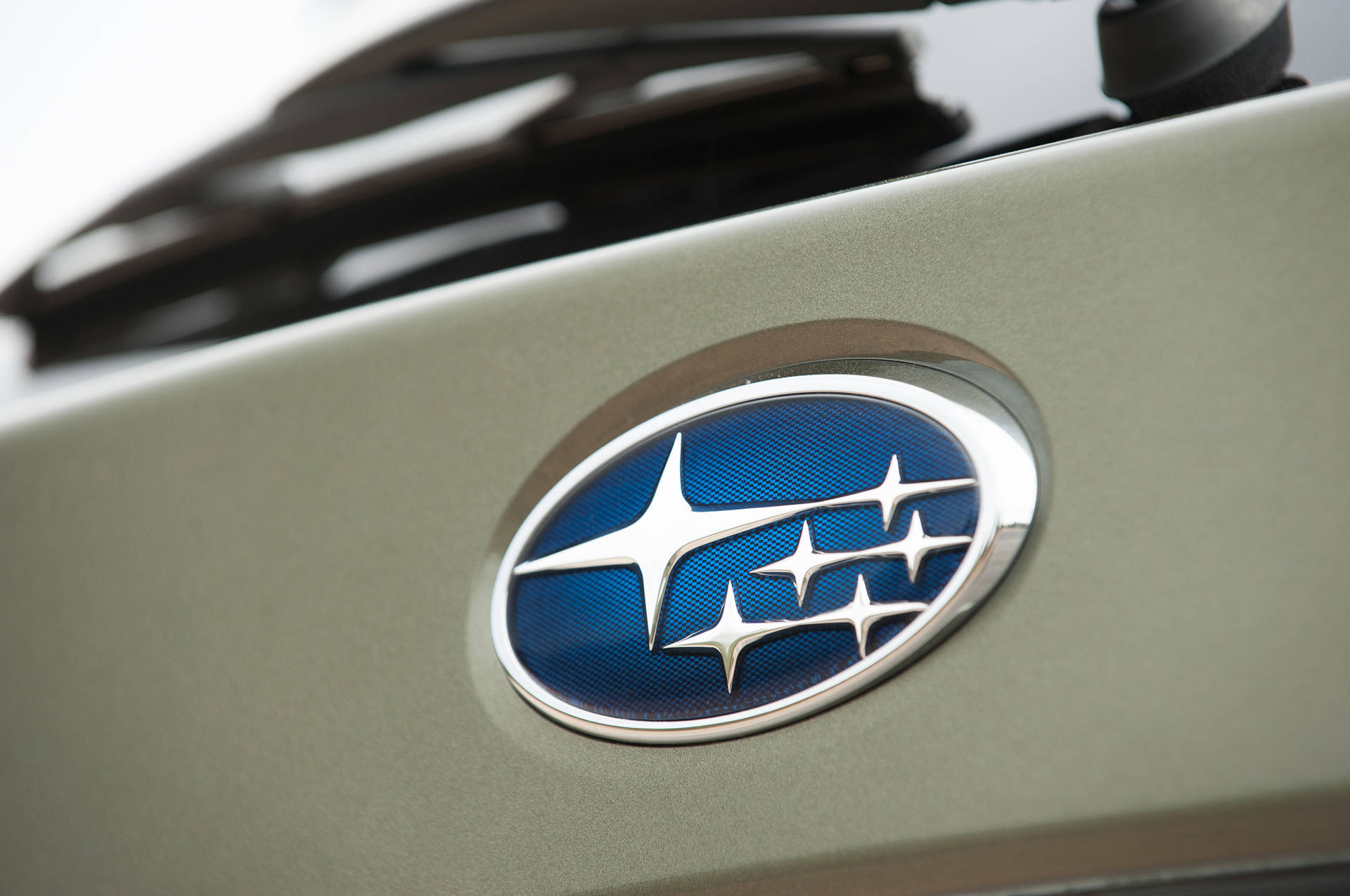 Subaru Logo On Gray Car Background