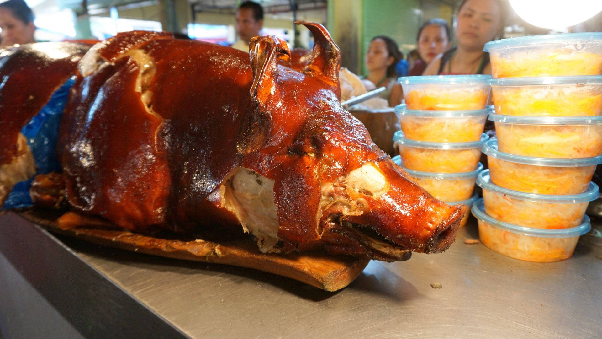 Succulent And Crunchy Lechon At A Local Market Background