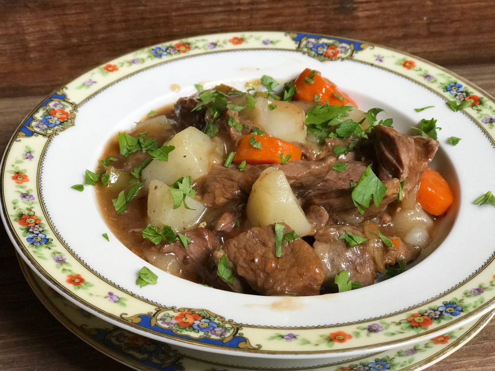 Succulent Beef Bourguignon Served With Potatoes Background