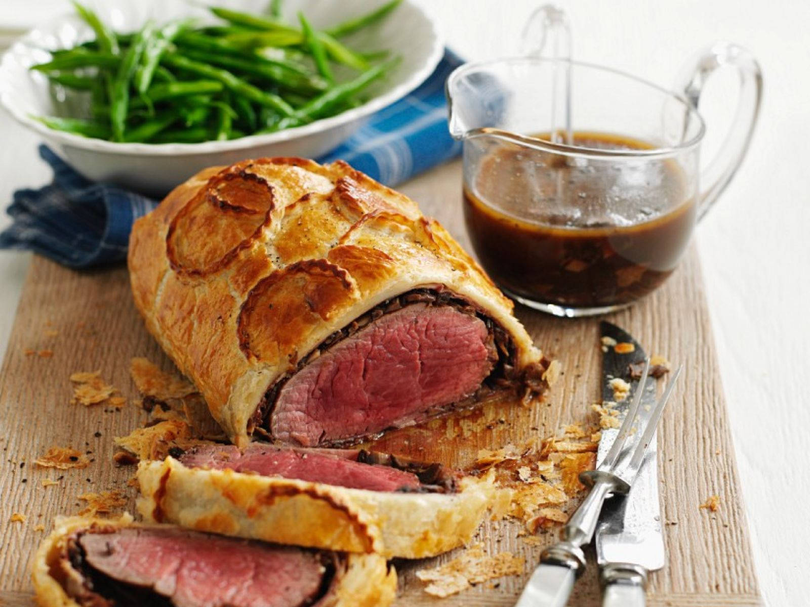 Succulent Beef Wellington Served With Asparagus And Sauce