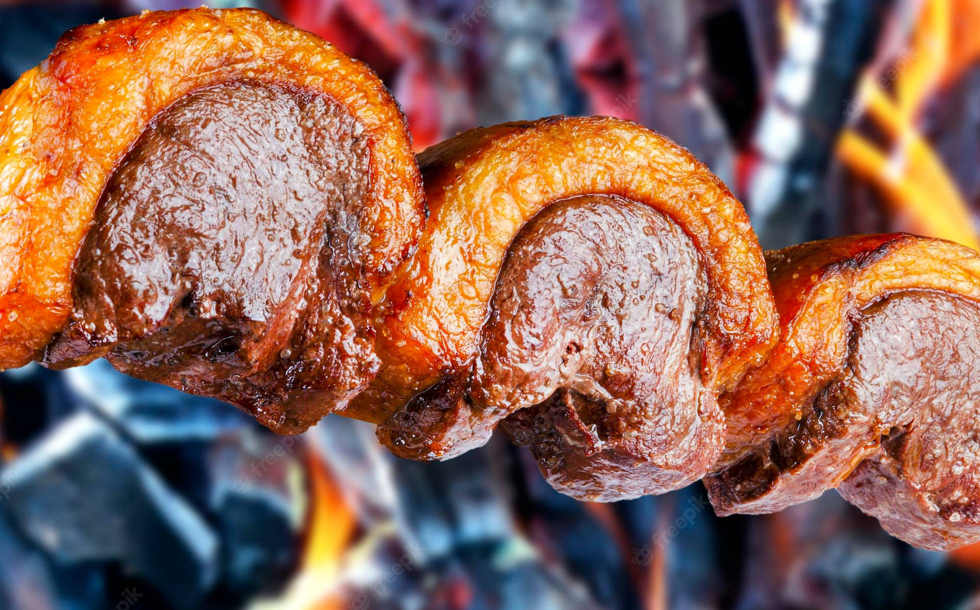 Succulent Picanha Churrasco Grilling Over Open Flame Background