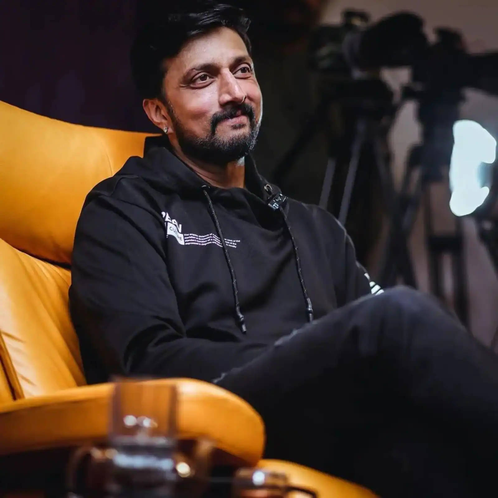 Sudeep Comfy In A Yellow Chair Background