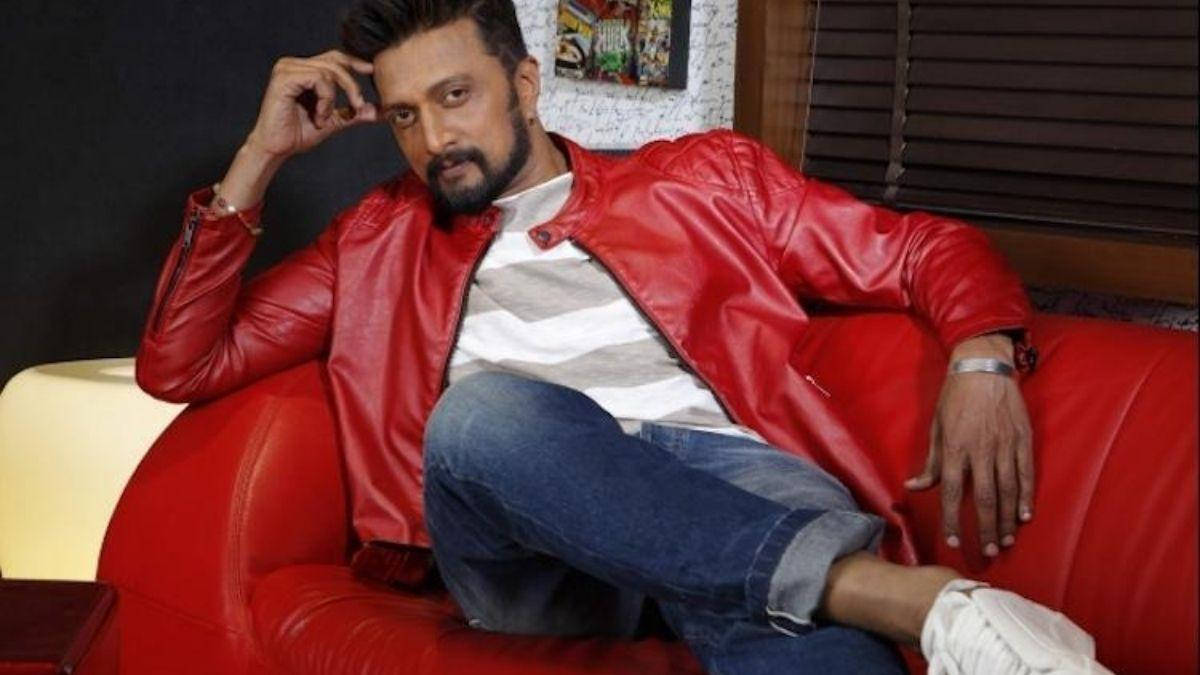 Sudeep On Plush Red Chair Background