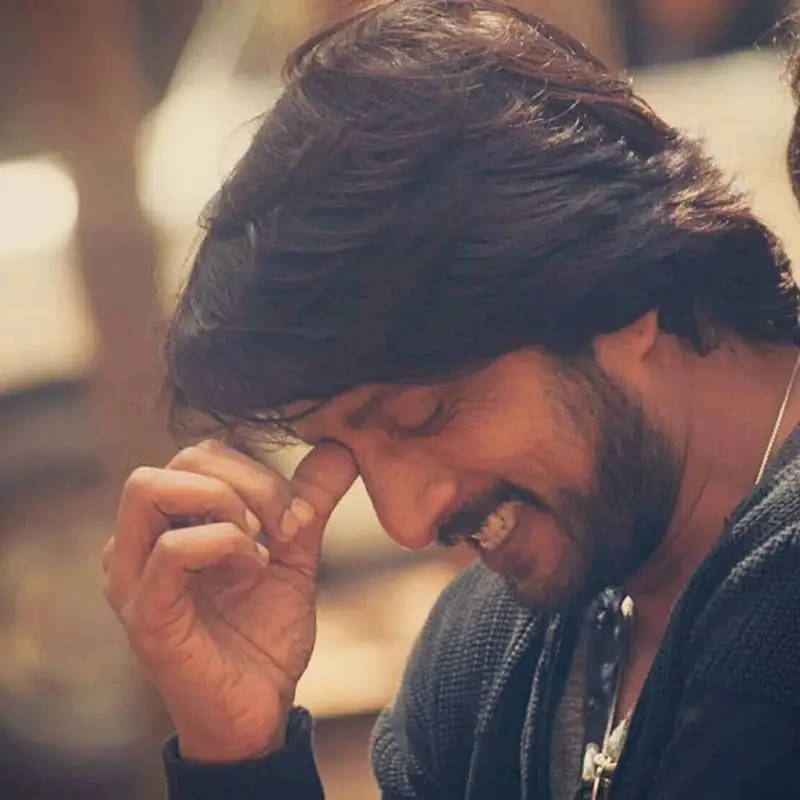 Sudeep Smiling By Himself Background