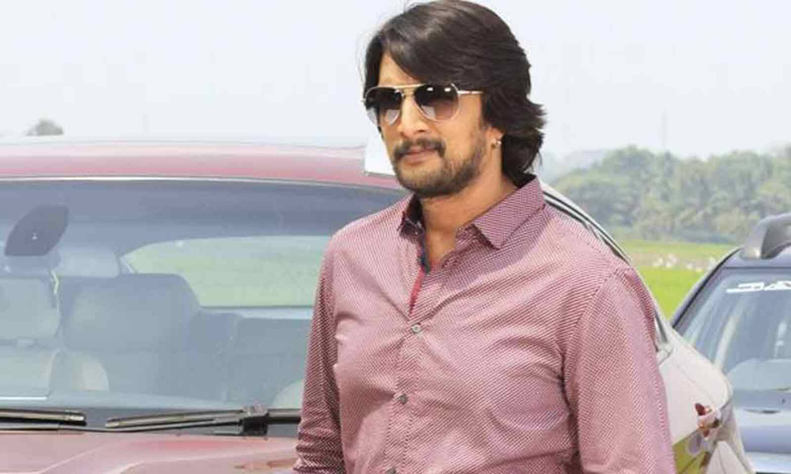 Sudeep Wearing Pink Polo Background