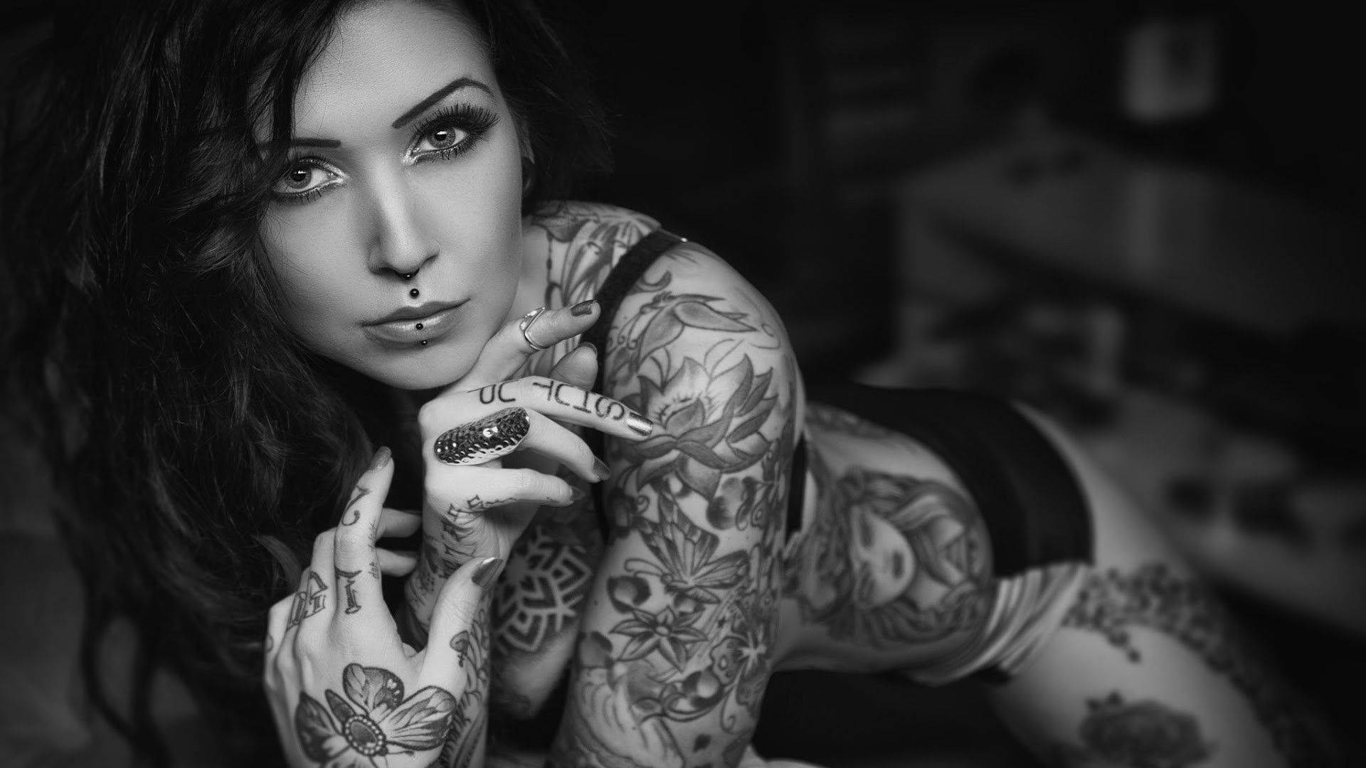 Sultry Woman With Tattoo Background