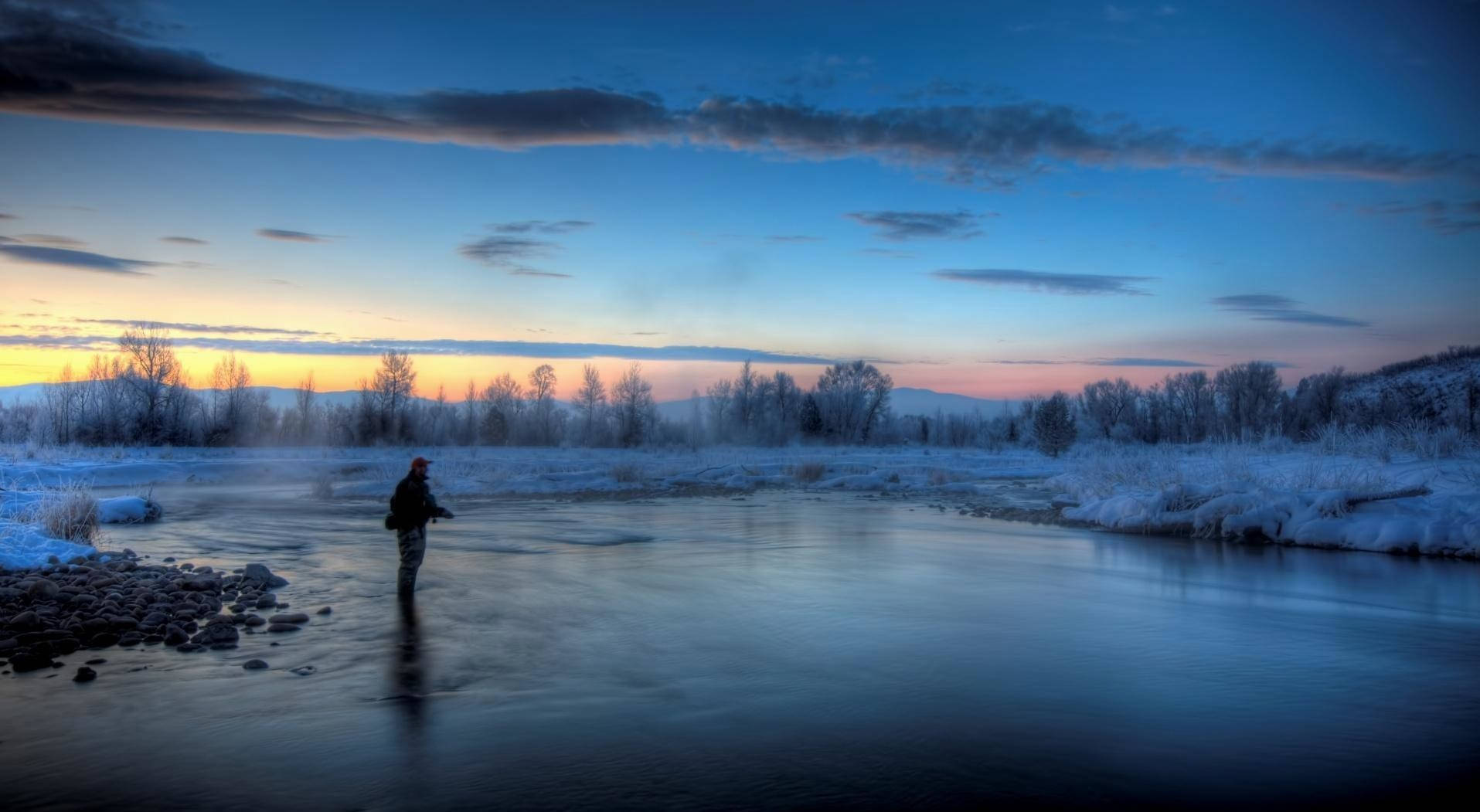 Summer Sets In As A Bass Fishing Enthusiast Enjoys The Thrill Of The Hunt Background