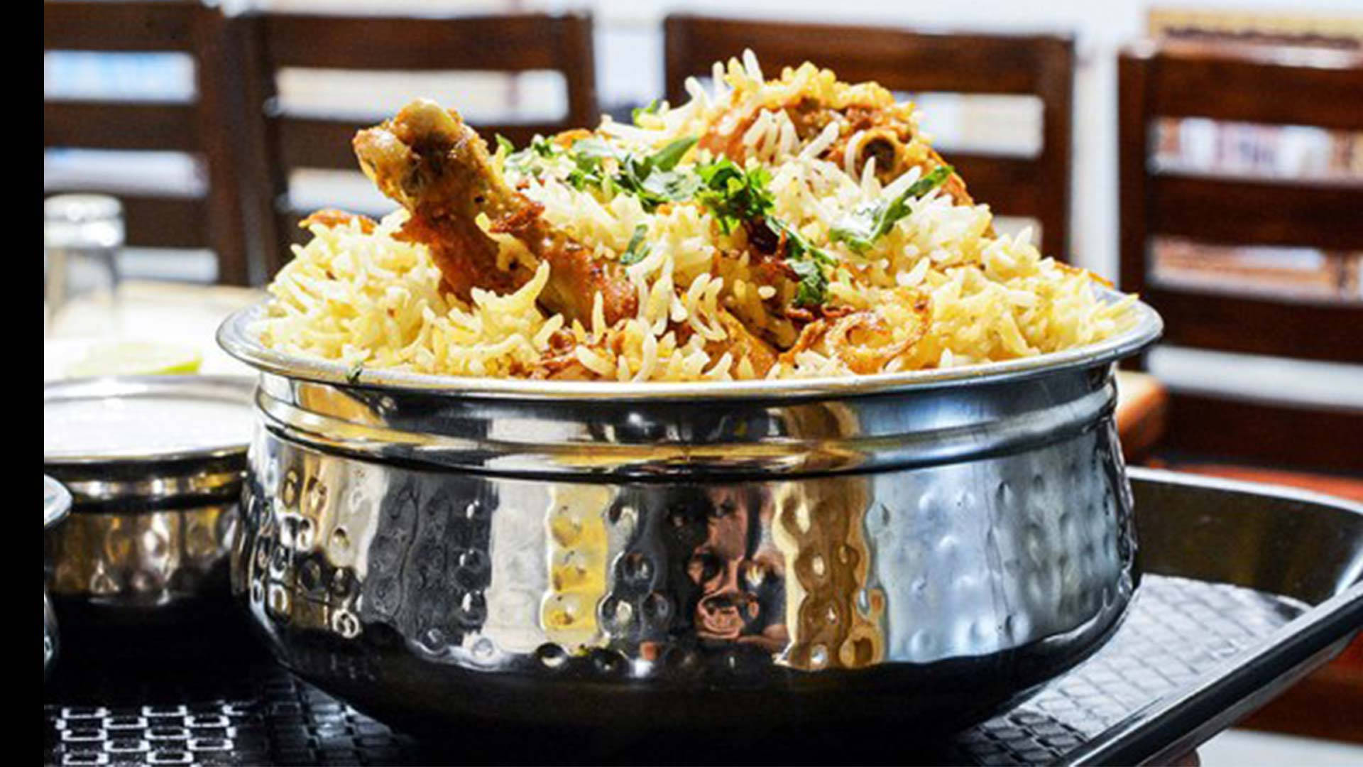 Sumptuous Biryani Served In A Silver Bowl Background