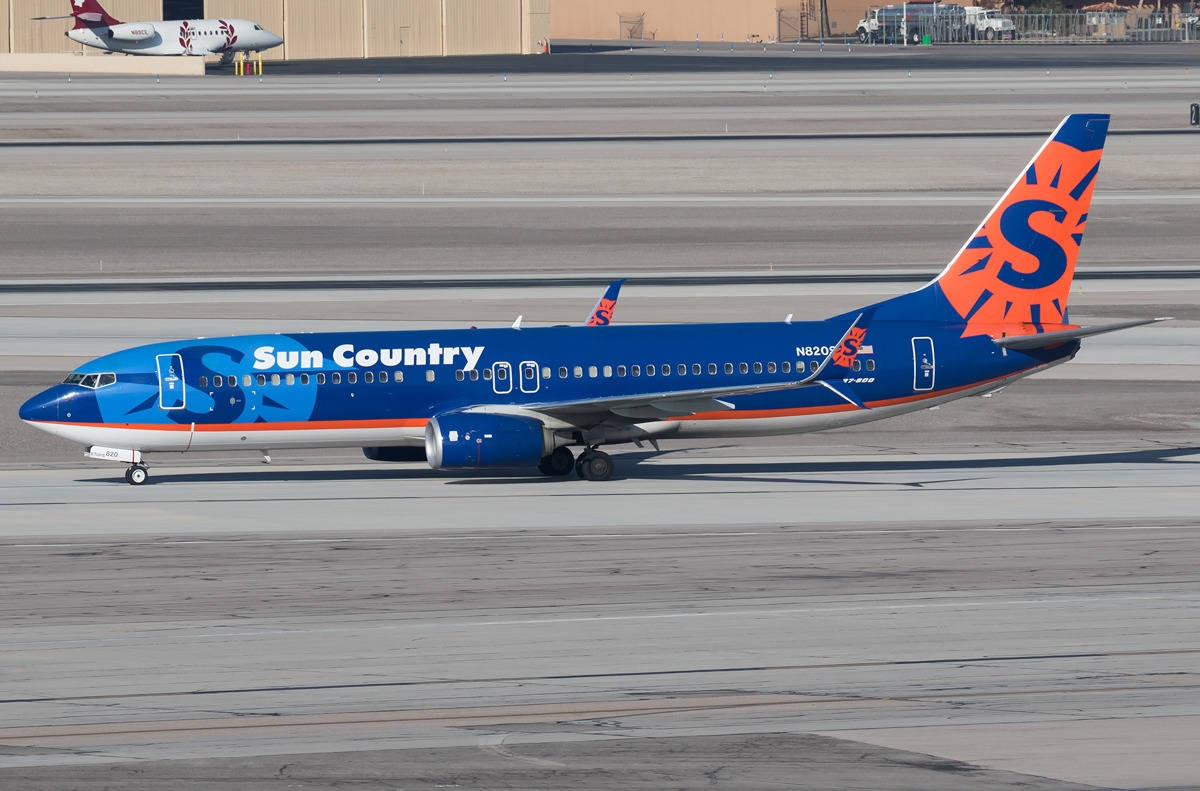 Sun Country Airlines Aircraft On Airport Tarmac Background