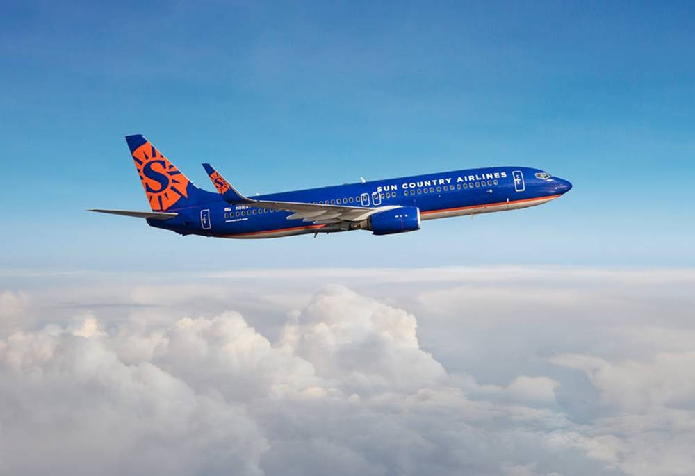 Sun Country Airlines In The Cloud Horizon Background