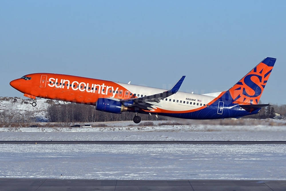 Sun Country On Snowy Airport Background