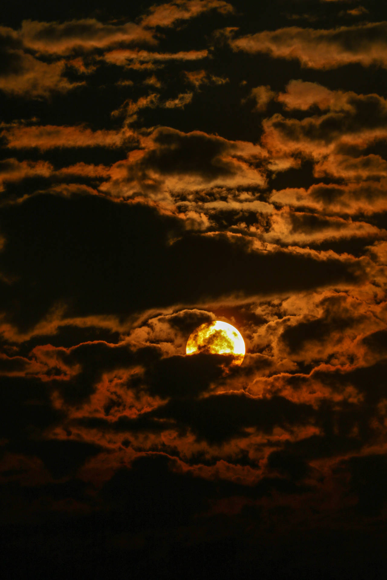 Sun In Dark Clouds Background
