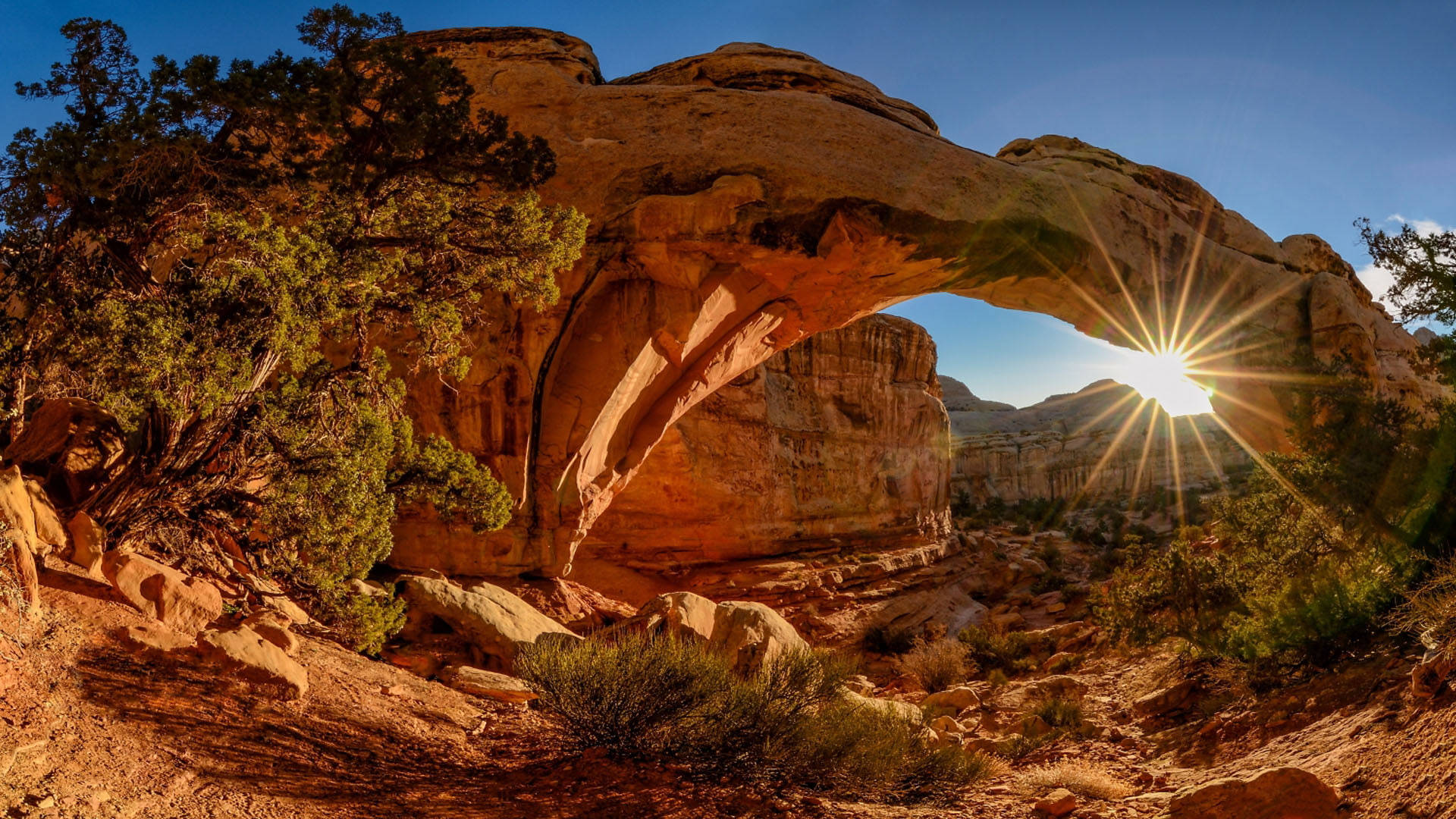 Sun Peeking At Arches National Park Background