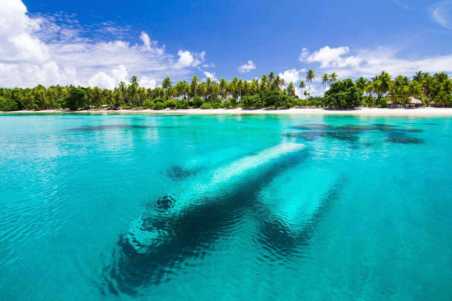 Sunken Wwii Airplane In The Clear Waters Of The Marshall Islands Background