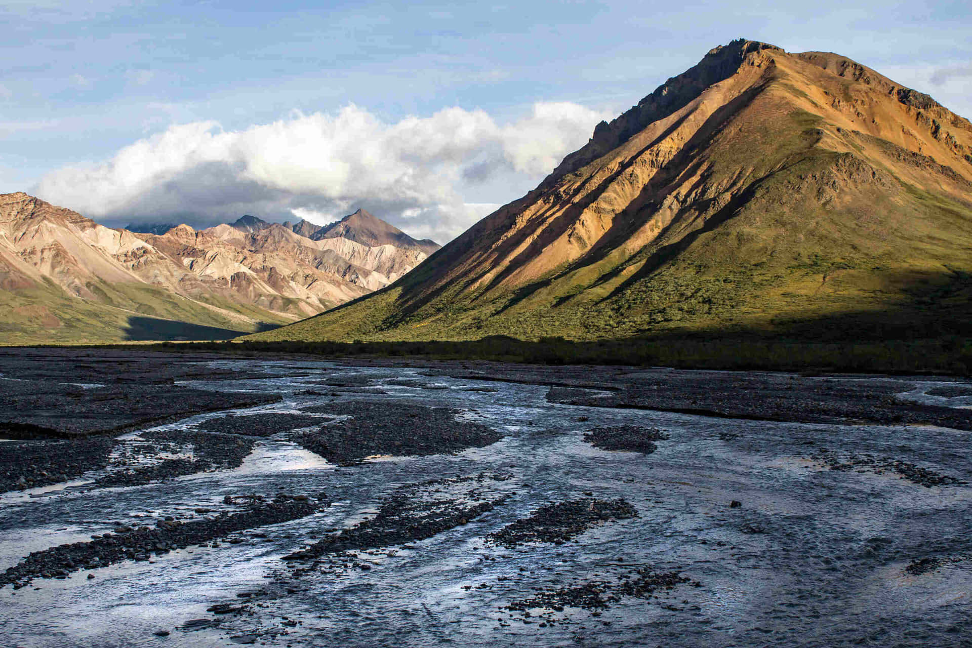 Sunlit_ Mountain_ Ridge_and_ Riverbed_ Alaska
