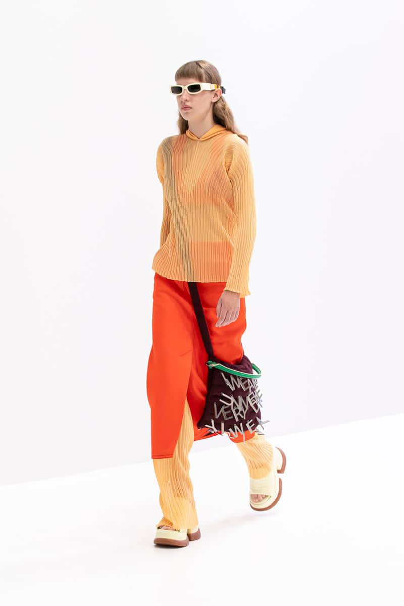 Sunnei Model With Orange-toned Outfit Background