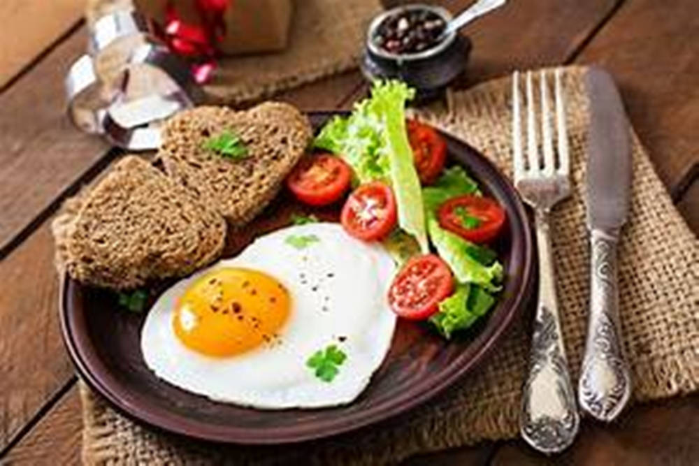 Sunny Side Up Eggs With A Salad And Toast Background